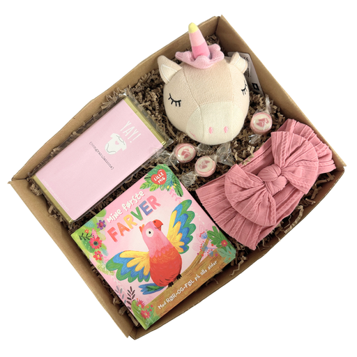 Sød lille gaveløsning med legetøj og udvikling til baby i lyserød